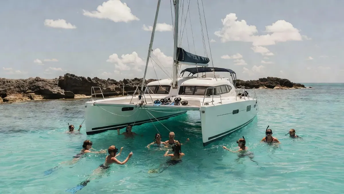 Catamaran anchored over turquoise water on a St Maarten snorkeling cruise near Creole Rock
